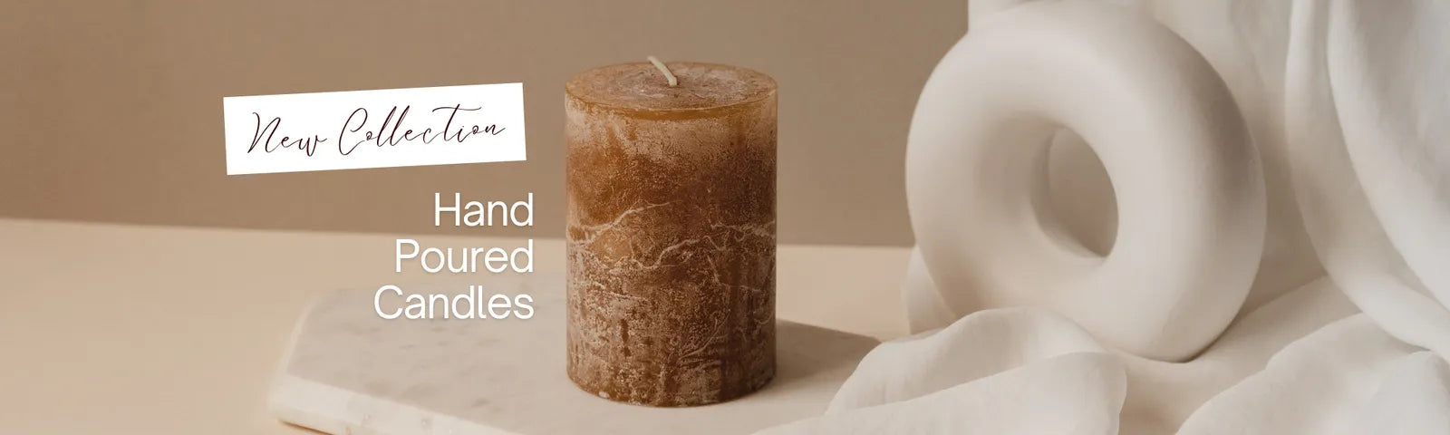 Hand poured candle on a stone surface with 'New Collection' text